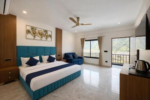 a bedroom with a blue and white bed and a couch at Riverline Gold Resort in Rishīkesh