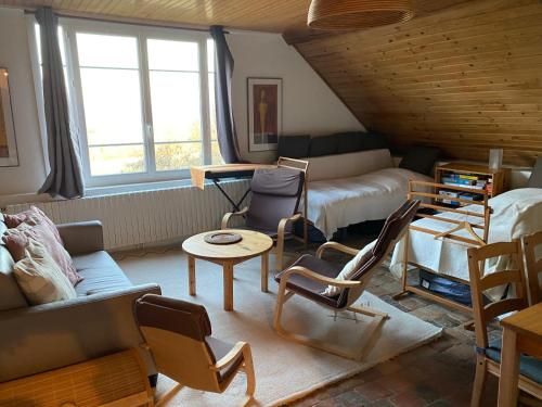 a living room with a couch and chairs at Le relais Poyo in Arquian