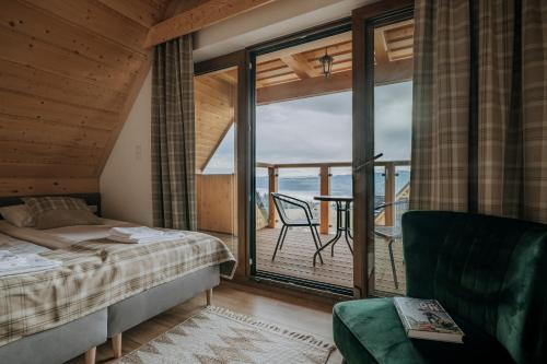 a bedroom with a bed and a view of the ocean at Osada Widokówka- Przystanek Podhale in Czorsztyn
