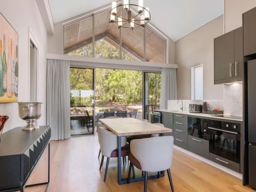a kitchen with a table and chairs and a dining room at Peppers Hunter Valley Accor Vacation Club Apartments in Rothbury