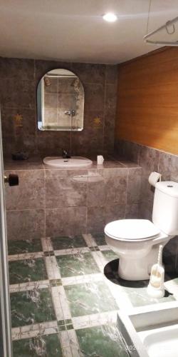 a bathroom with a toilet and a sink and a tub at A morada do peregrino in Poio