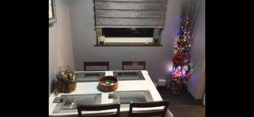 a dining room with a table and a christmas tree at City apartment no.8 in Norwich