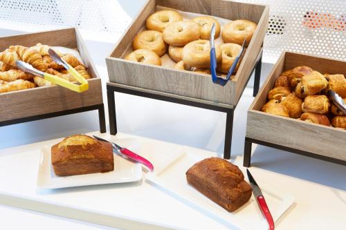 a table topped with two boxes of bread and pastries at ibis Styles Paris Charles de Gaulle Airport in Roissy-en-France