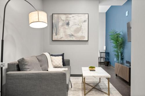 a living room with a couch and a table at CozySuites At Presshouse in Pittsburgh