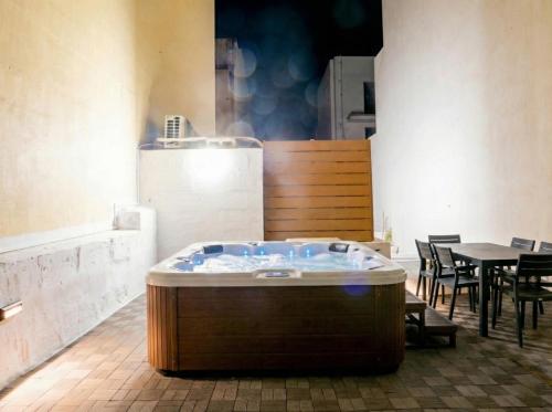 a hot tub in a room with a table and chairs at Villa Luciano - Rooftop Jacuzzi, BBQ, Billiards & Steps from Sea in Sliema