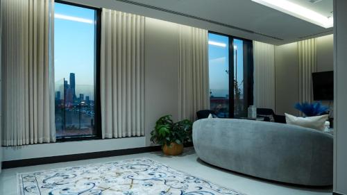 a large room with a tub and large windows at ارتاما بوتيك للشقق المخدومة in Riyadh