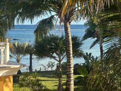 a view of the ocean from a resort with palm trees at Palmar Bay - Beachside Villa in Palmar
