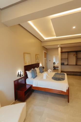 a bedroom with a large bed in a room at Elephanto Hotel LTD in Zanzibar City