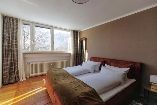 a bedroom with a large bed with white pillows at Red Fox Apartment in Garmisch-Partenkirchen
