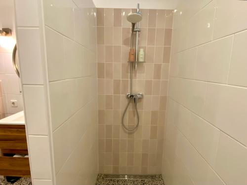 a bathroom with a shower with a shower head at Apartment Havenstraat in Delft