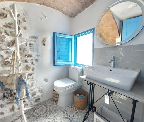 a bathroom with a toilet and a sink and a mirror at Casa el far Peñíscola in Peniscola