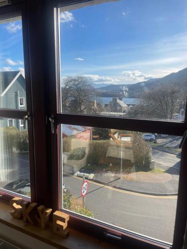 a window with a view of a street at Misty Isles View in Portree
