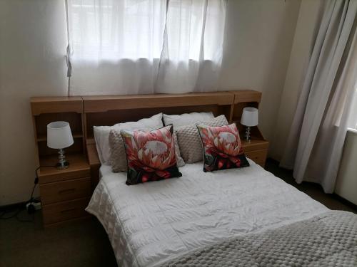 a bedroom with a bed with two pillows on it at Mimosa House Double Room in Brackenfell