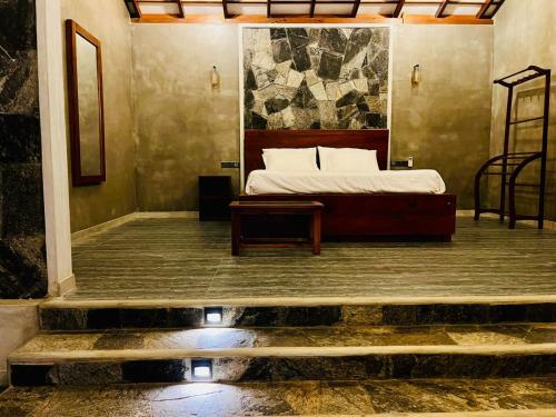 a bedroom with a bed and a table in a room at Villa Stillrock in Dodanduwa