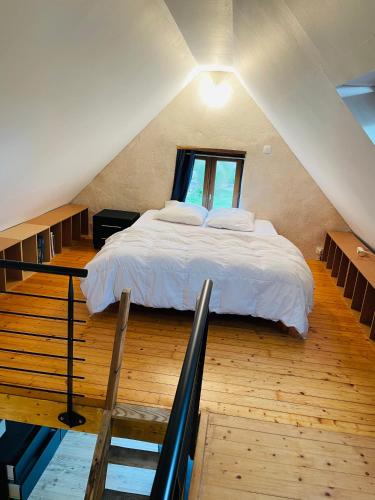 a bedroom with a large bed in a attic at Dépendance chez l'habitant in Morlaix