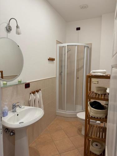 a bathroom with a sink and a shower and a toilet at La Casa Gialla in Lucca