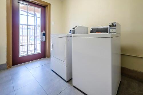 a kitchen with a refrigerator and a printer on top of it at Red Roof Inn Arlington - Entertainment District in Arlington