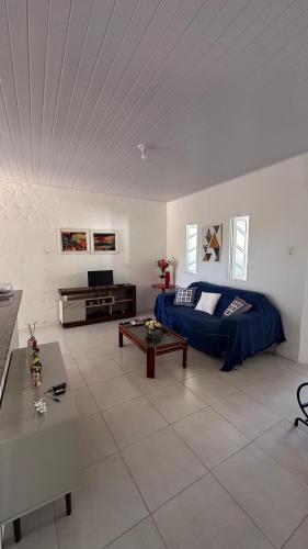 a living room with a couch and a table at Casa Lagoa & Praia in Estância