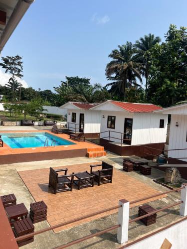 a resort with a swimming pool and some buildings at Resort Ideal Forest in São Tomé