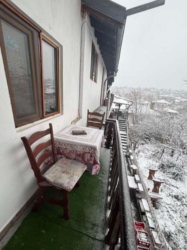 a room with a table and chairs on a balcony at dato in Arbanasi