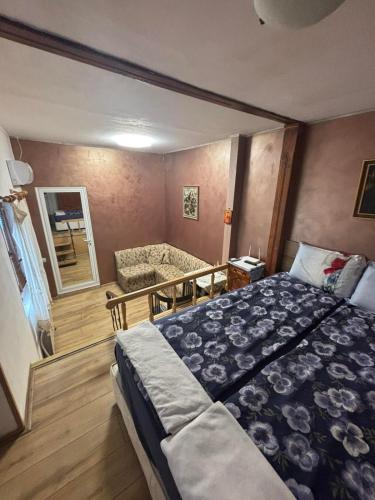 a bedroom with a large bed and a bathroom at dato in Arbanasi