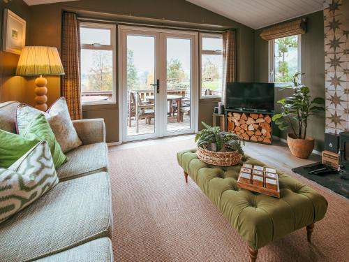 a living room with a couch and a television at The Shepherd - Uk50613 in Sabden