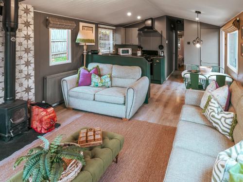 a living room with two couches and a stove at The Shepherd - Uk50613 in Sabden
