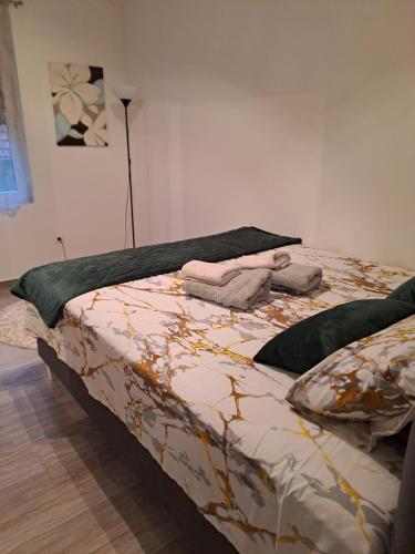 a bedroom with a bed with a comforter on it at Stan na dan M in Smederevska Palanka