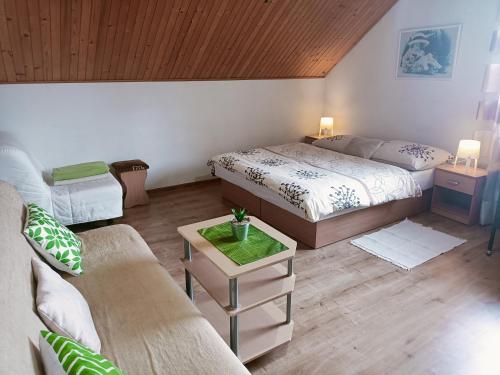 a living room with two beds and a couch at Privat Mária in Liptovský Ján