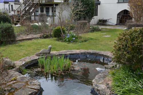 a pond with a bird sitting on top of it at The Smugglers Inn in Minehead