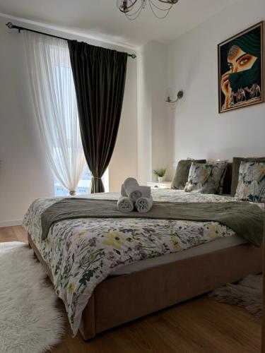 a bedroom with a large bed with a large window at Panoramic RESIDENCE in Baia Mare