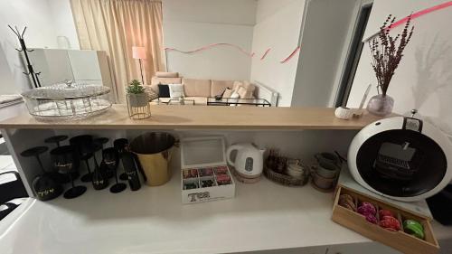 a kitchen with a shelf with various items on it at Hideaway in Ostrava