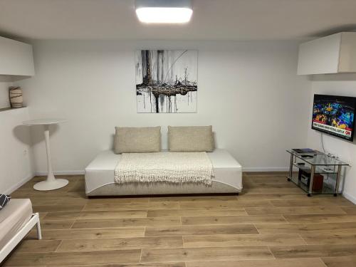a bedroom with a bed and a wooden floor at City center in Čadca