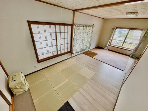 an empty room with two windows in a room at 和野 湯沢 in Yuzawa