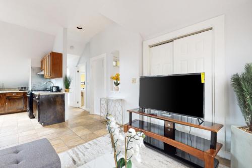 a living room with a large flat screen tv at 3 Mi to Franklin Park Zoo! Bright Residential Stay in Boston
