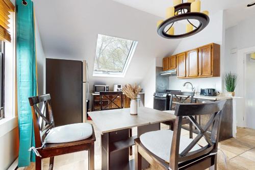 a kitchen with a wooden table and chairs in a kitchen at 3 Mi to Franklin Park Zoo! Bright Residential Stay in Boston