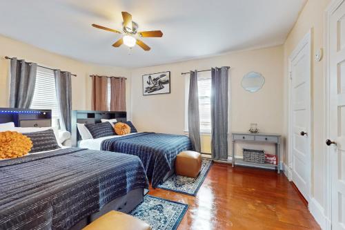 a bedroom with two beds and a ceiling fan at 3 Mi to Franklin Park Zoo! Bright Residential Stay in Boston