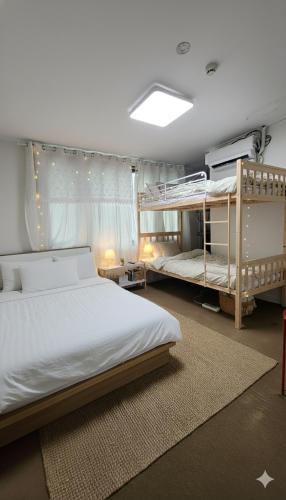 a bedroom with two bunk beds and a bedskirts at SPACE Guesthouse in Seoul