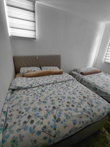 a bedroom with two beds and two windows at Apartment Victoria in Foča