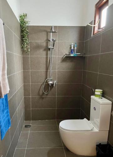 a bathroom with a toilet and a shower at The Tide's Tale in Galle
