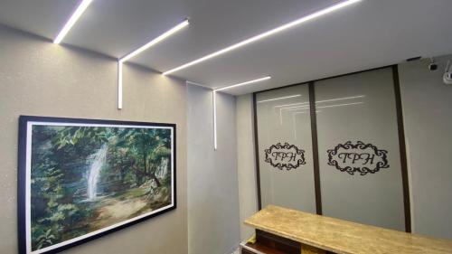 a room with a painting on a wall with lights at Tawfiqs Hotel in Barra do Garças