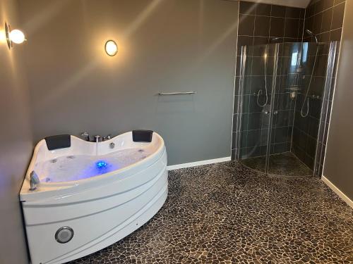 a bathroom with a large tub and a shower at Herning, Sunds Lake Beautiful View & Spa 105 m2 in Sunds