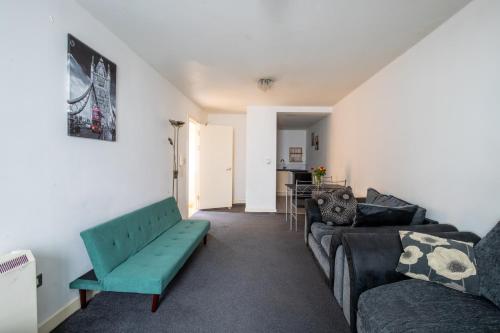 a living room with a couch and a table at Manchester City Square in Manchester