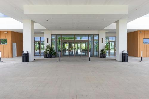 an empty lobby of a building with glass doors at Four Points by Sheraton Georgetown in Georgetown