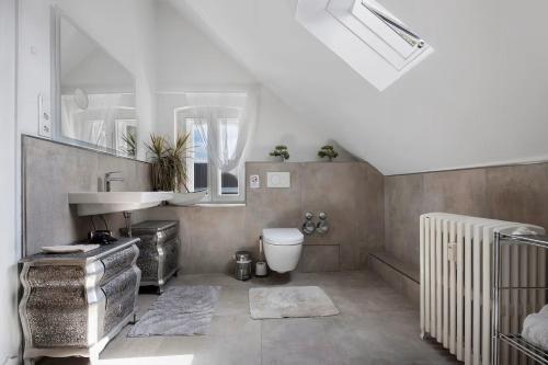 a bathroom with a sink and a toilet and a mirror at Boardinghouse am Herforder Tor für 8 Personen auf 185 m2 in Bad Salzuflen