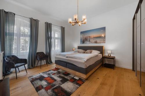 a bedroom with a bed and a chandelier at Boardinghouse am Herforder Tor für 8 Personen auf 185 m2 in Bad Salzuflen