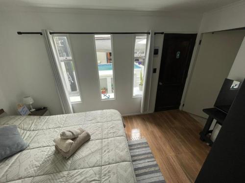 a bedroom with a bed with a towel on it at Tayka Suite in La Serena