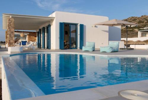 a swimming pool in front of a villa at Villa Salt in Naxos Chora