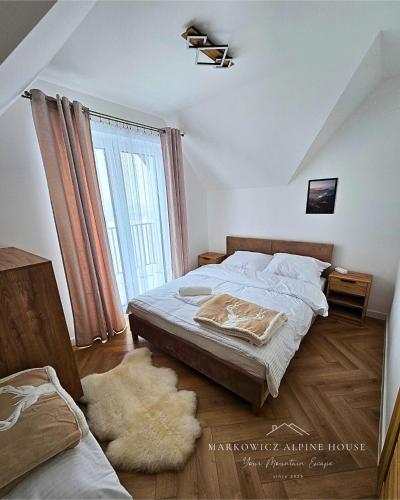 a bedroom with a bed and a large window at Markowicz Alpine House in Szaflary