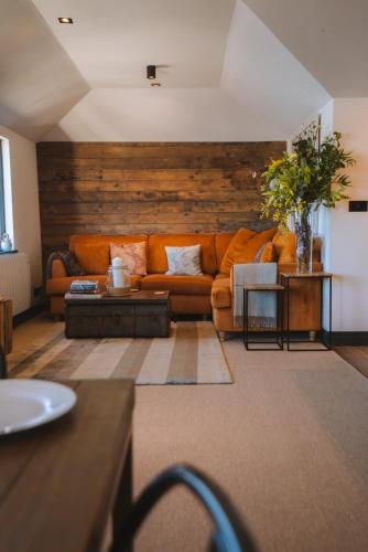 a living room with a couch and a table at Stunning Waterfront Apartment With Spectacular Views & Parking at 'CAPTAINS LOFT' in Falmouth